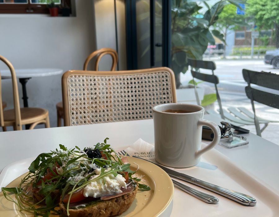 Avocado toast and a cup by the window
