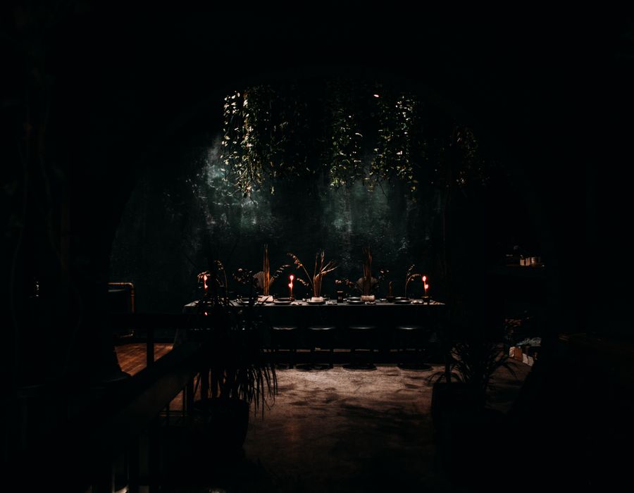 A corner table set with candles
