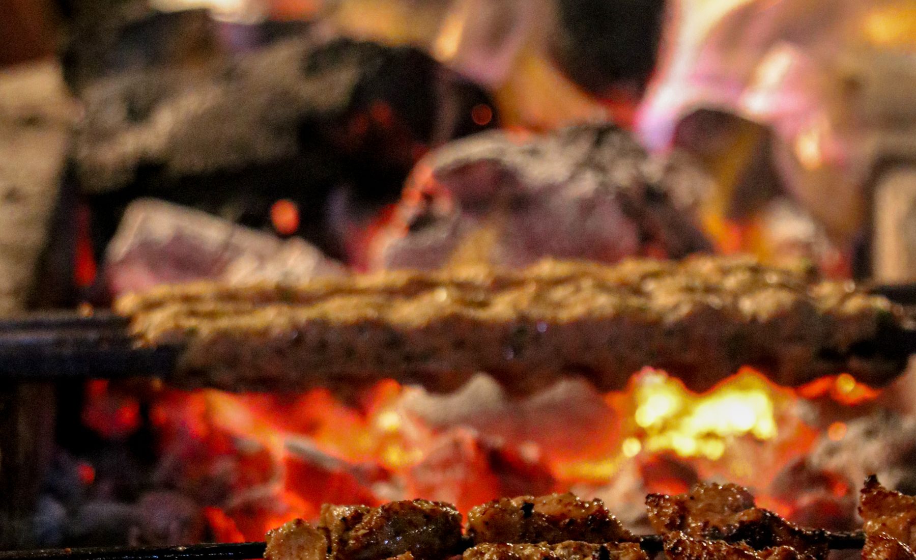 Hardwood charcoal burning down in the pit